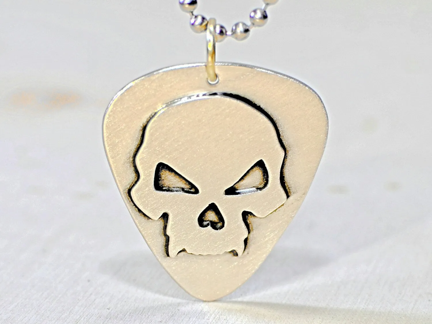 Skull design on sterling silver guitar pick for a bad ass guitarist