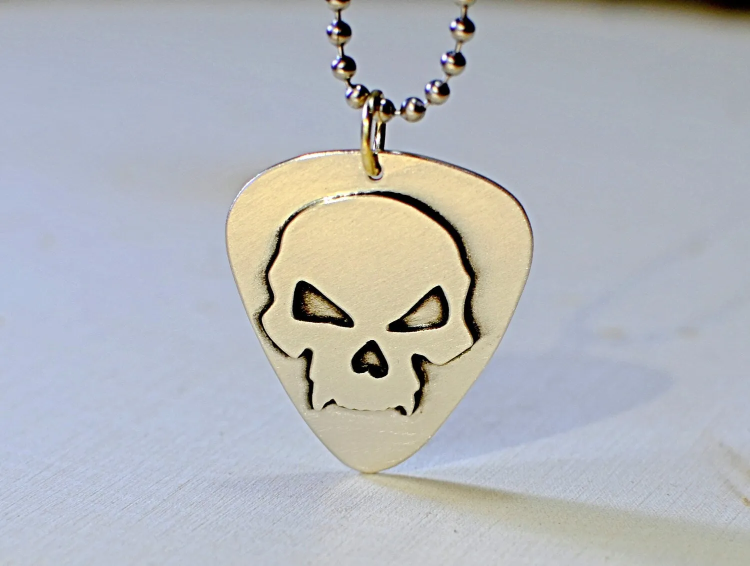 Skull design on sterling silver guitar pick for a bad ass guitarist