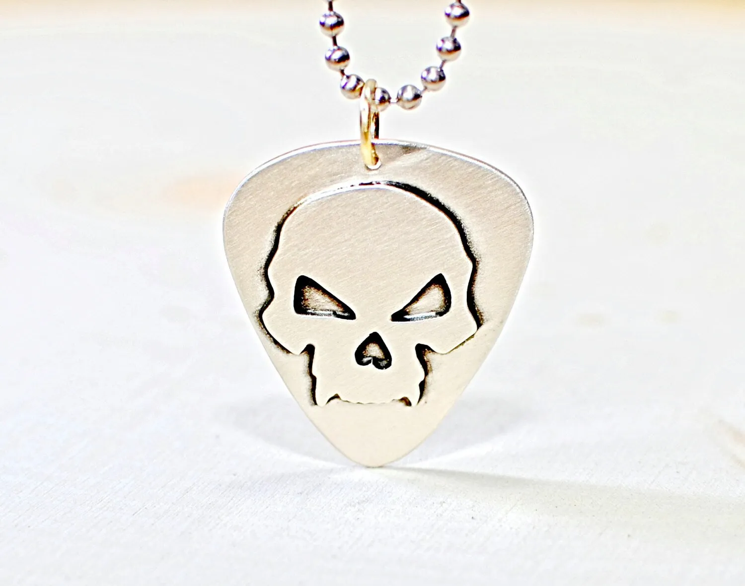 Skull design on sterling silver guitar pick for a bad ass guitarist